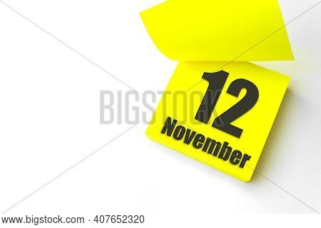 November 12nd. Day 12 Of Month, Calendar Date. Close-up Blank Yellow Paper Reminder Sticky Note On W