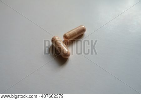 Pair Of Pink Capsules Of Probiotic Dietary Supplement