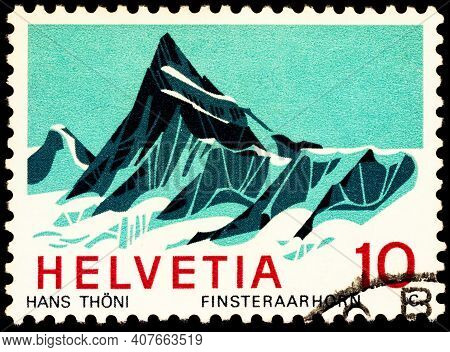 Moscow, Russia - February 09, 2021: Stamp Printed In Switzerland Shows Finsteraarhorn Mountain, Seri
