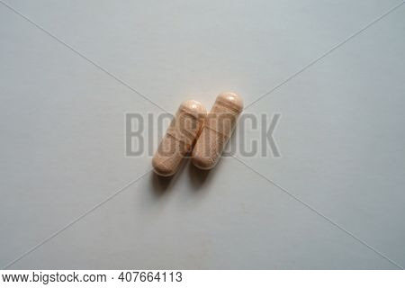 View Of Two Pink Capsules Of Probiotic Dietary Supplement From Above