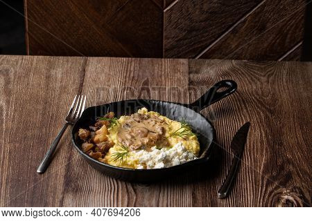Banosh - A Traditional Dish In The Western Ukraine Made Of Cornmeal. Served In A Black Pan With Crac