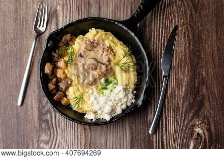 Banosh - A Traditional Dish In The Western Ukraine Made Of Cornmeal. Served In A Black Pan With Crac