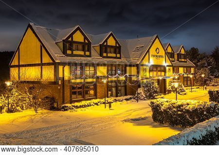 Gdansk, Oliwa, Poland - 16 January 2021 - View Of The Illuminated, Snow-covered Old Town In Oliwa. F