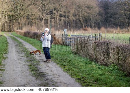 Mature Woman With Her Gimbal Mobile Phone Tripod Head Stabilizer Filming In A Nature Reserve With Ba