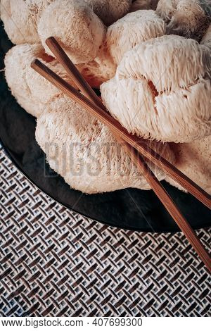 Hericium Erinaceus Or Lions Mane Mushrooms On A Plate With Chinese Sticks. Medical Mushroom Concept