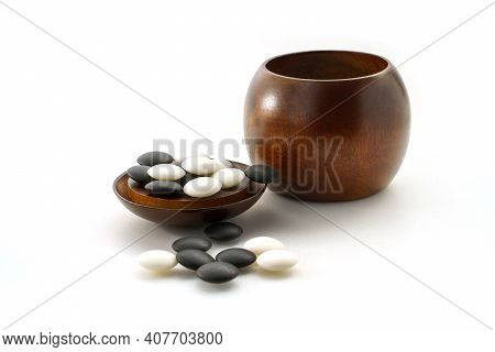 Black And White Stones Of Baduk Game On Wooden Board Isolated On White