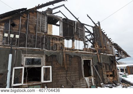 Burnt Wooden House. House After The Fire. House Destroyed In A Gas Explosion .