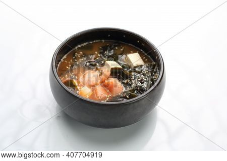A Bowl Of Misoshiru Soup With Salmon Isolated On White.