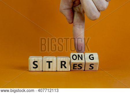 Strong Stress Symbol. Businessman Turns Wooden Cubes With Words 'strong Stress'. Beautiful Orange Ba