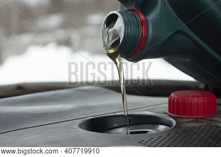 Engine Oil Change. Refueling With Fresh Engine Oil. Filler And Conistra Close-up.
