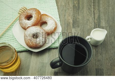 Donuts Sprinkled With Powdered Sugar On A Plate. Powdered Sugar Donuts With Copy Space
