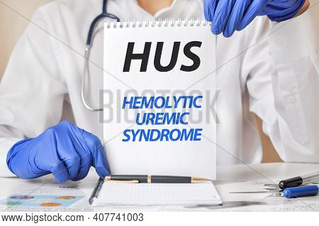 Hus Card In Hands Of Medical Doctor. Doctor's Hands In Blue Gloves Holding A Sheet Of Paper With Tex