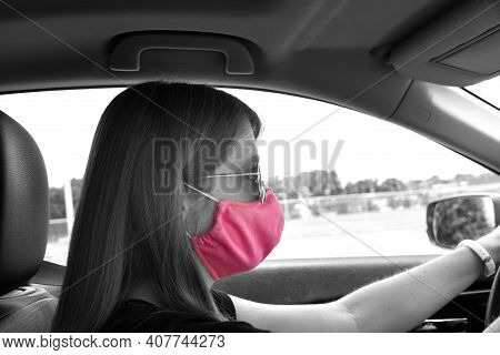 Black And White Image Has Color Pop Of Pink.  Young Woman Drives In Memphis With Her Pink, Cloth Fac