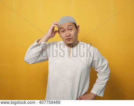Portrait Of Asian Muslim Man Looks Confused And Worried Gesture, Don't Know What To Do, Facing Big P