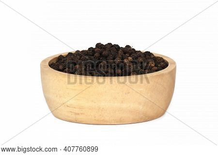 Black Pepper (black Peppercorns) In Wooden Bowl Isolated On White Background.