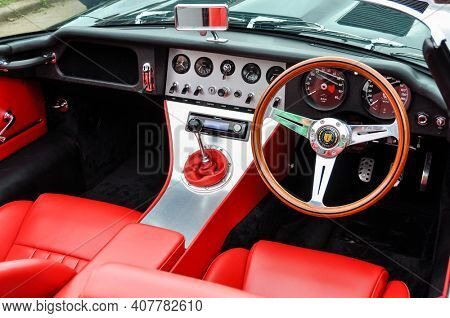 LONDON, UK - CIRCA SEPTEMBER 2011: Eagle E-Type Speedster dashboard, red leather seats. The Eagle E-Type is a restored and modified Jaguar E-Type.