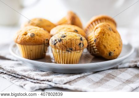 Vanilla muffins. Sweet cupcakes on plate.