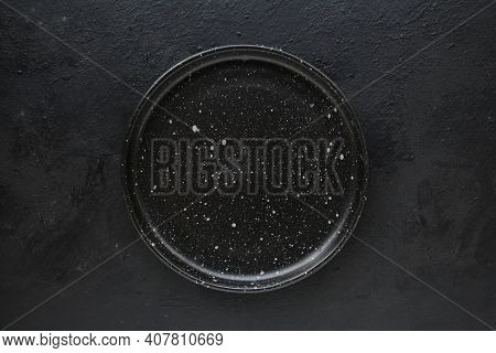 Empty Black Ceramics Plate And On Dark Background.