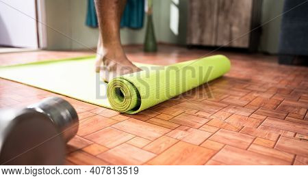Young Man At Home Arranging Yoga Mat Before Starting Exercise - Concept Of Medical, Helathcare, Fitn