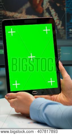 Close Up Of Scientist Woman Holding Tablet With Green Mockup In Modern Equipped Lab. Team Of Microbi