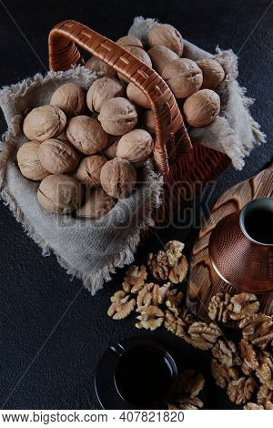 Walnuts In A Basket On A Dark Background. Coffee In A Copper Turk. The Kernel Of A Walnut. Wooden Bo