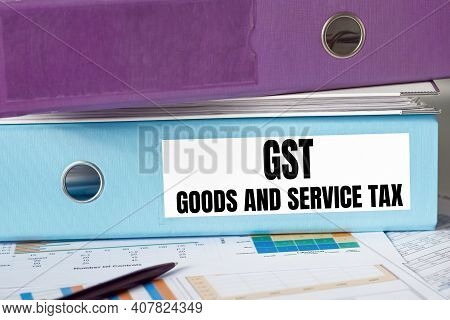 Gst - Goods And Service Tax Acronym, Business Concept On Blue Office Folder