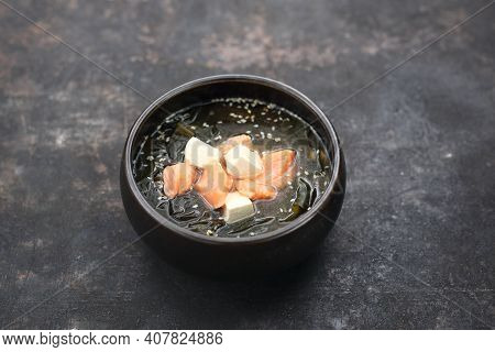 An Oriental Japanese Soup With Salmon In A Traditional Bowl, Close-up. A Misoshiru.