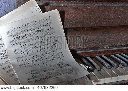 November 2020, Italy. Antique Piano With A Musical Score, In A Living Room Of An Abandoned House In 