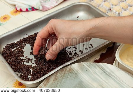 Hand Picking Up Brigadeiro On Aluminum Tray. The Brigadeiro Is A Traditional Brazilian Dessert. Top 