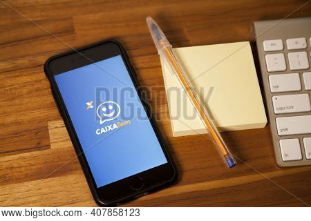 São Paulo, Brazil. Feb 12, 2021: Cell Phone With The Image Of The Cashier App Has On The Wooden Tabl