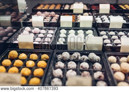 Assortment Of Chocolate Colorful Candies Desserts On Cafe Showcase. Variety Of Sweets With Different