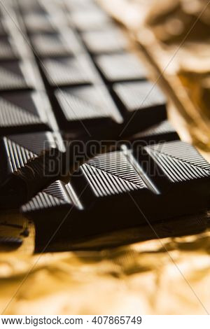 Close Up Of Healthy Dark Chocalate Bar On Gold Foil