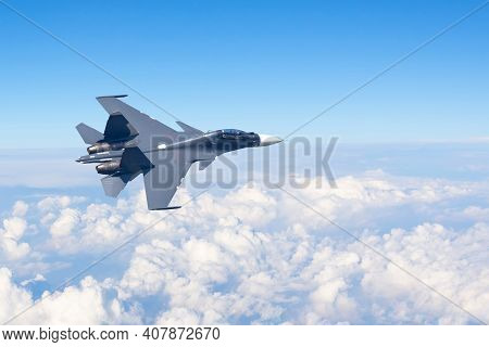Combat Fighter Jet Flies Turning Maneuver High In The Sky Above The Clouds