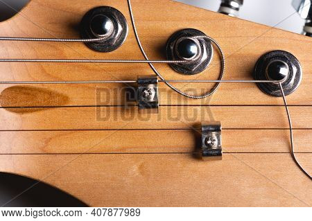 Guitar Fretboard With Tuning Pegs And Strings On A Gray Background. Close-up