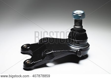 New Spare Parts Axel Car Elements. Off-road Ball Joint Car Suspension On A Gray Background.