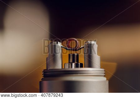 Vaping Device With A Hot Spring On A Black Background For Evaporation.