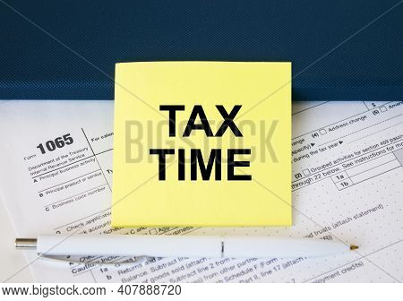 Tax Form 1065 With Yellow Sticker With Text Tax Time. Notepad And White Pen