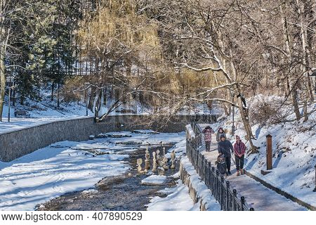 Kislovodsk, Russia - January 23, 2021: Winter Or Spring Landscape. Olkhovka River. People Walk Along