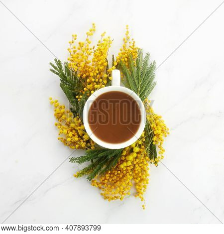 Cup Of White Coffee With Yeallow Mimosa Flowers. Flat Lay, Top View.