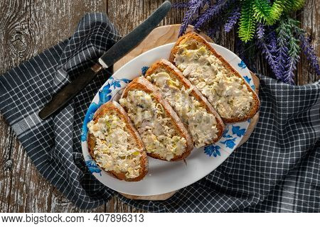 Sandwiches With A Paste Of Mackerel, Egg And Cucumber On A Wooden Table.