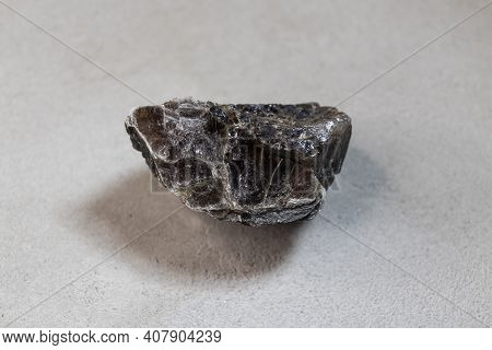 A Sample Of A Mineral Found In The Arctic On Dixon Island, On A Gray Background, Close-up.
