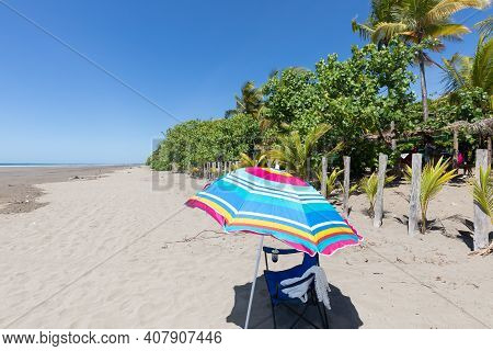 Panama Armuelles, Beach Umbrella With Chair On A Sunny Day