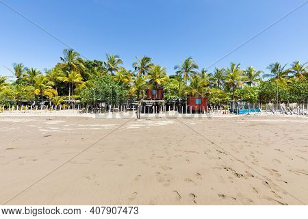 Panama Armuelles, Red House On Stilts Among The Palm Trees Of The Beach