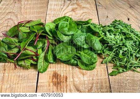 Mix Salad Leafs, Arugula, Spinach And Swiis Chard. Wooden Background. Top View
