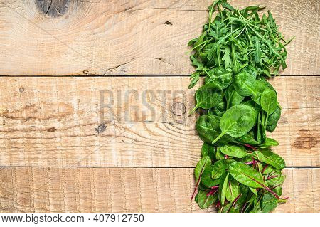 Mix Salad Leafs, Arugula, Spinach And Swiis Chard. Wooden Background. Top View. Copy Space