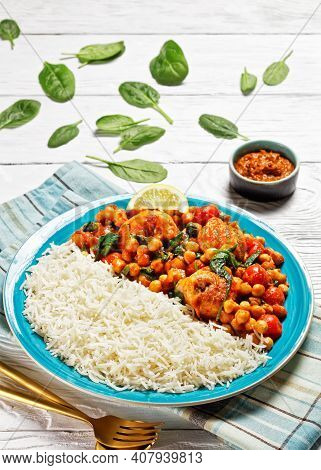 Chicken And Chickpea Curry Served With Jasmine Rice With Cherry Tomatoes, Baby Spinach, Yellow Curry