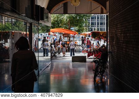 Strasbourg, France - July 29, 2017: People Walking Via Tunnel Toward Market Stall In Central Strasbo
