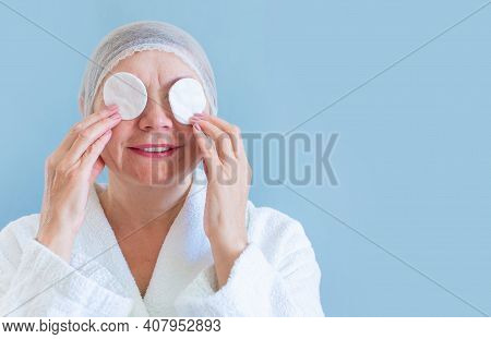 Anti Age Concept. Happy Natural Woman Seniora With A Cotton Pad Cleanses The Skin. Natural Spa Treat