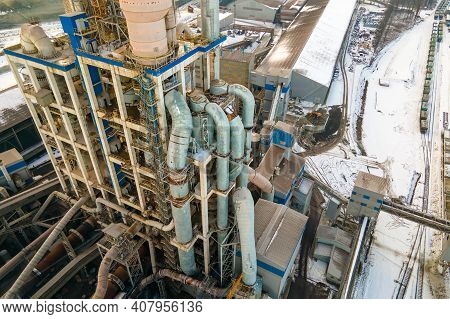 Aerial View Of Cement Plant With High Factory Structure And Tower Crane At Industrial Production Are