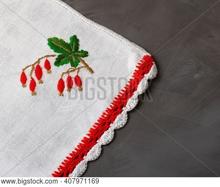 Nepkin With Handmade Embroidery Red Berries On A Gray Background